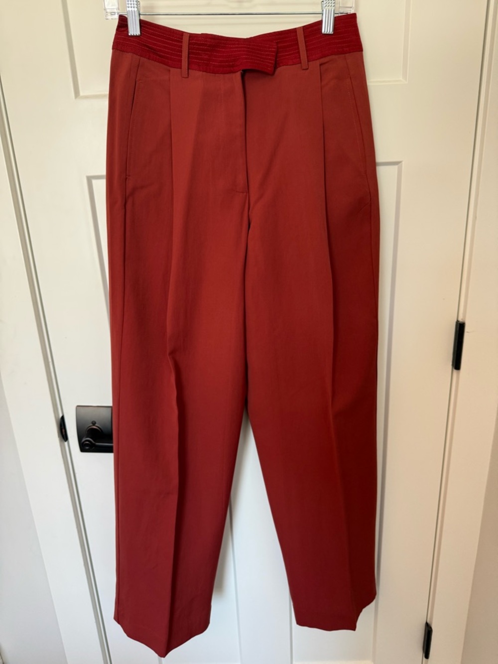 NWOT Tiny high rise pleated pants in a rich burnt orange/red color. Size 4.